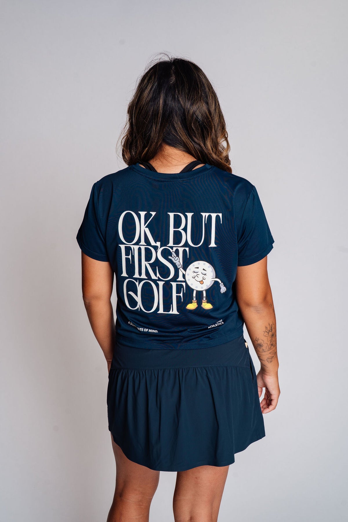 The Scord OK But First Golf graphic tee, a women's golf t-shirt — detail view